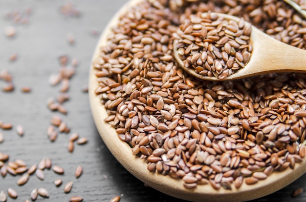 Linseed or flax seed in wooden bowl with small spoon