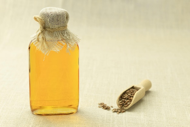 Linseed oil with kitchen utensils on an old wooden table