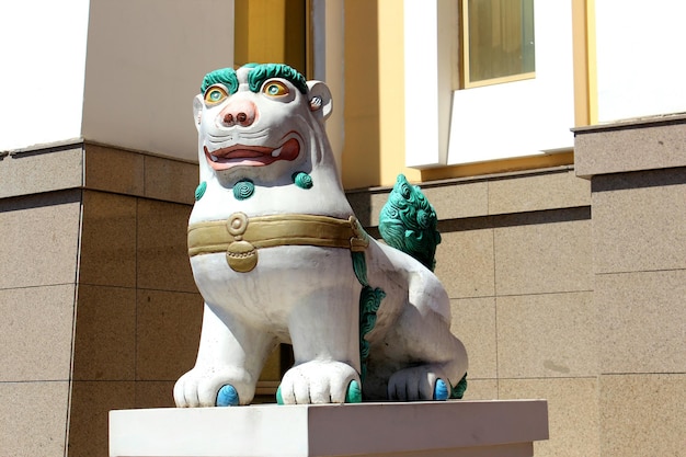 Photo lion statue against building during sunny day