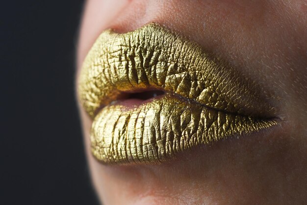 Lip icon with golden glitter effect sensual mouth symbol of kiss from golden lipstick glamour luxury
