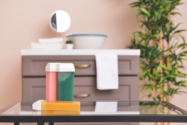 Liposoluble wax cartridges on table in bathroom