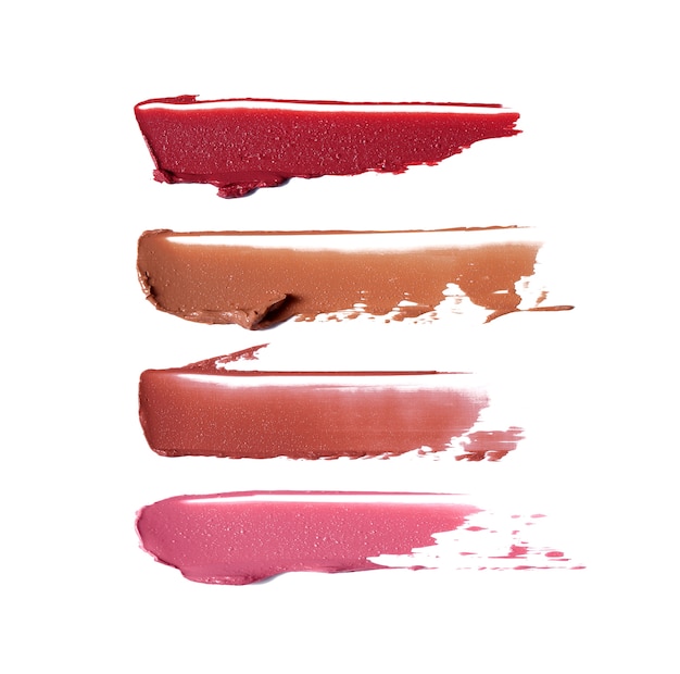 Photo lipstick brush strokes in different shades isolated on white