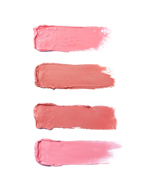 Photo lipstick brush strokes in different shades isolated on white