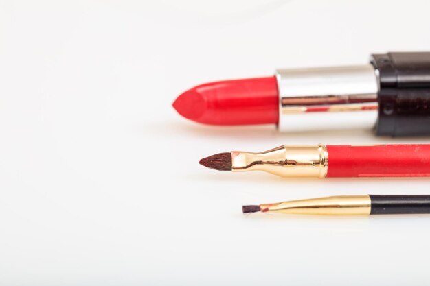 Lipstick and brushes isolated on white background