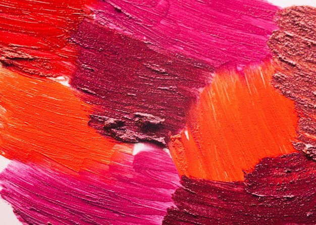 Lipstick pink burgundy orange palette smudge background texture