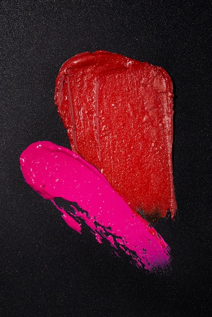 Lipstick shades on dark background flat lay