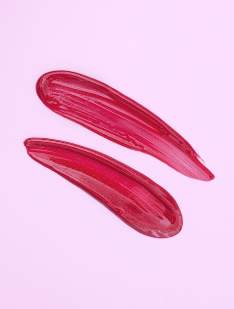 Lipstick smear sample lip gloss on pink background