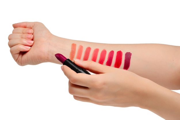 Lipstick swatches on woman hand isolated on white background