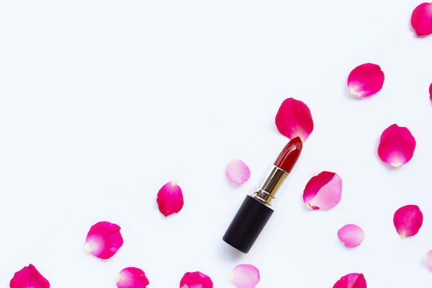 Lipstick with rose petals isolated background