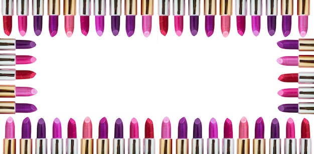 Lipsticks various colors frame against white background copy space