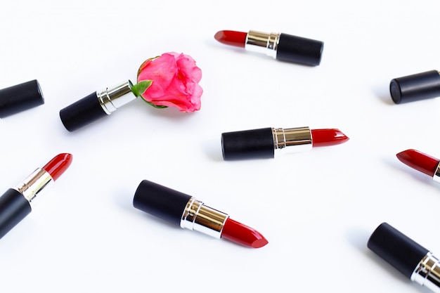 Lipsticks with rose flower on  white. 