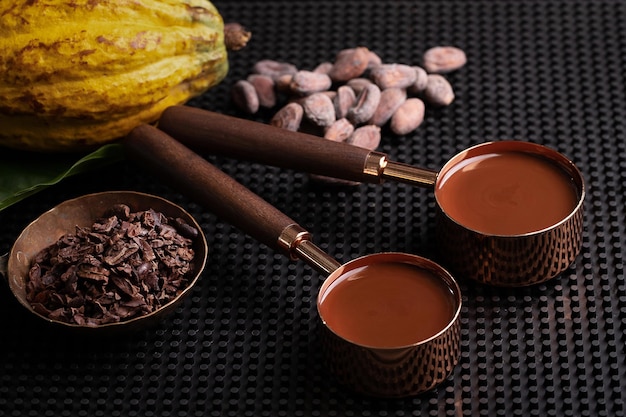 Liquid chocolate or cocoa in a measuring spoon