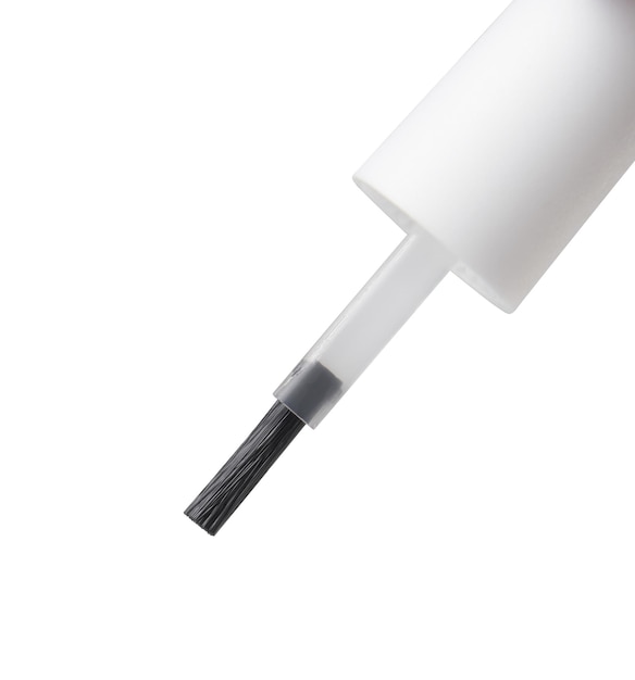 Liquid flows down on nail brush on the isolated white background