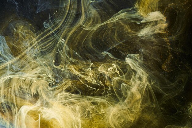 Liquid fluid art abstract background Black yellow dancing acrylic paints underwater space smoke ocean