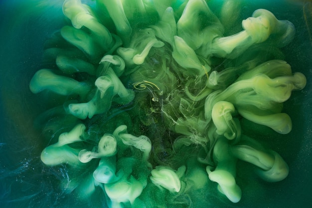 Liquid fluid art abstract background Green dancing acrylic paints underwater cosmic smoke ocean