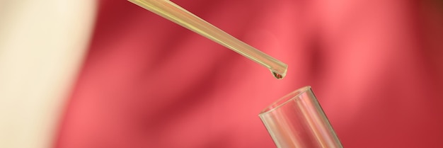 Photo liquid from pipette drips into test tube closeup concept of scientific research