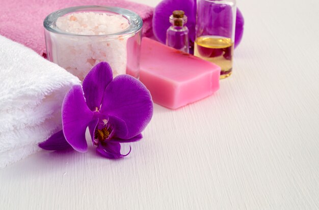 Liquid soap and two towels on a white background