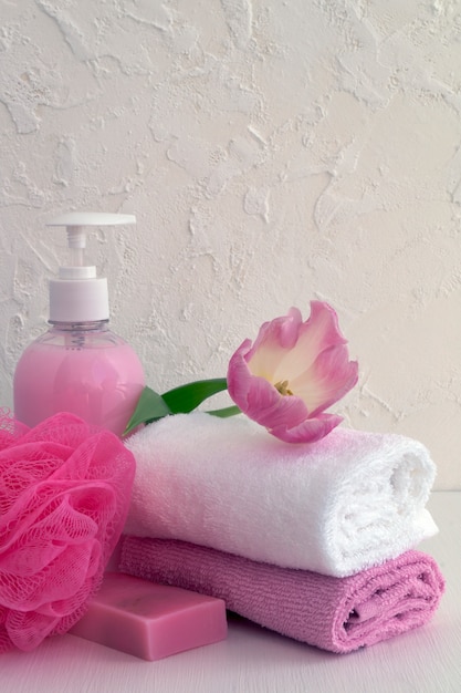 Liquid soap and two towels on a white background.