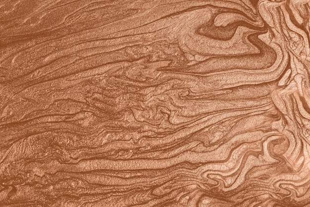Фото Жидкая текстура блестящего лака для ногтейабстрактный фон, окрашенный в персиковый цвет