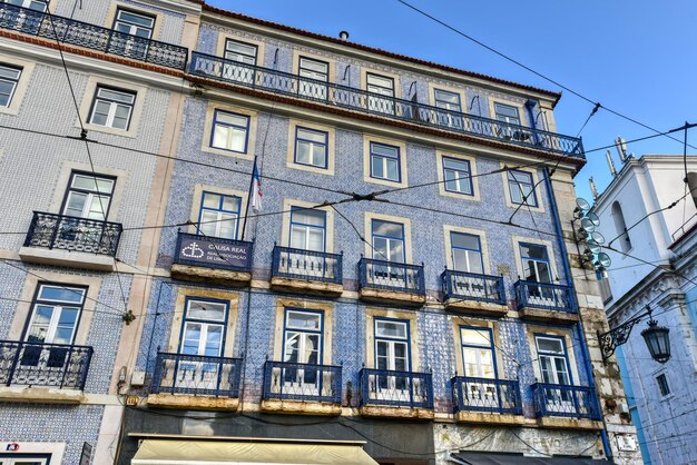 Lisbon windows with typical portuguese tiles on the wall