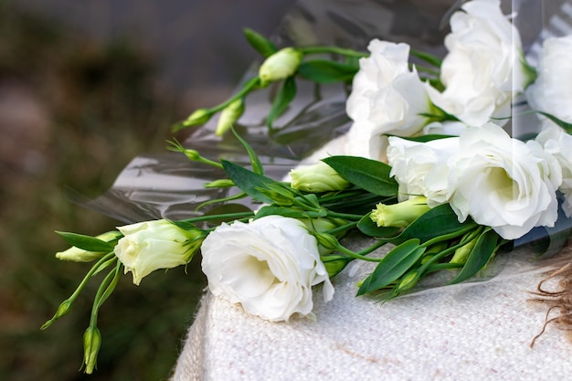 Lisianthus white bouquet is on the table.