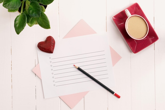 To do list in notepad with pencil and heart on wooden background