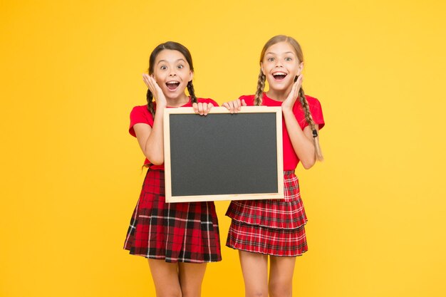 List of winners information office school project presentation copy space children presenting bulletin board big sales happy small girls with blackboard place for announcement