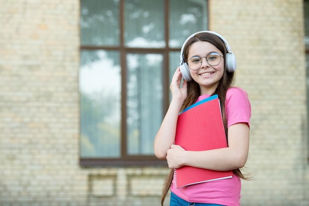 Listen for education you want happy child wear headphones\
outdoors listen technologies listening comprehension english school\
modern lifestyle audio courses language is future copy space