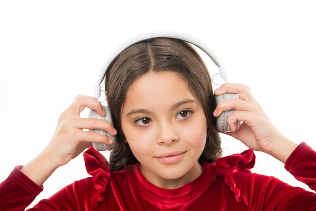 Listen for free new and upcoming popular songs right now. Little girl listen music wireless headphones. Online music channel. Girl little child use music modern headphones. Music always with me.