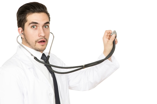 Listen to this! Studio shot of a male doctor holding out a stethoscope towards copyspace on the side