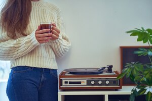 listen to music on vintage retro vinyl turntable with record and enjoying cozy time