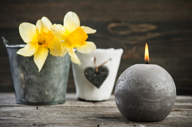 Photo lit candle and yellow flowers