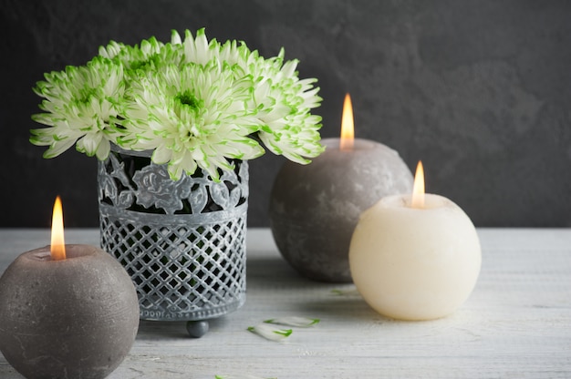 Lit candles and green chrysanthemum