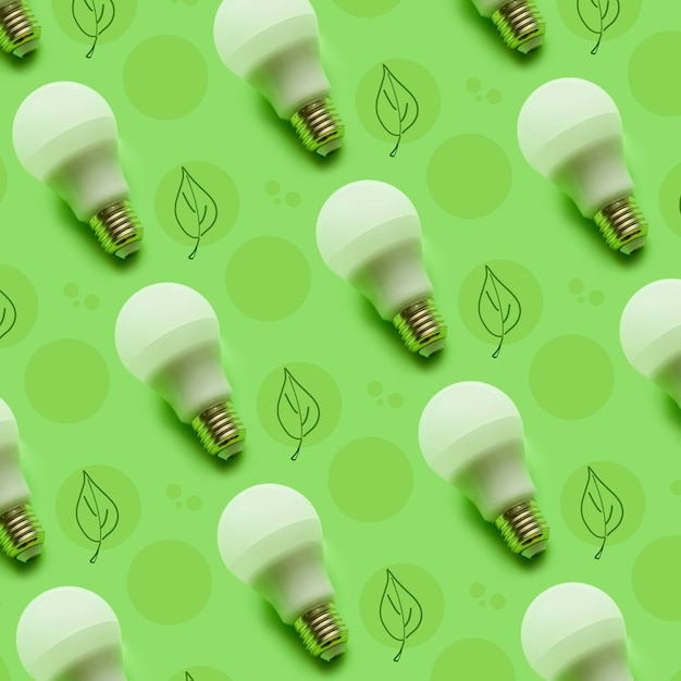 Lit light bulb pattern on green background