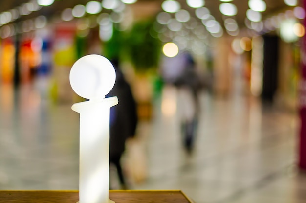 A lit up light sculpture with a large white figure in the middle.