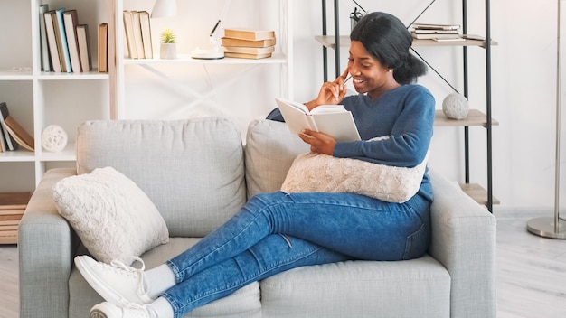 Literature leisure reading hobby book weekend joyful young woman enjoying interesting novel story