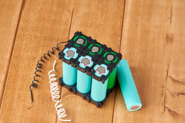 Lithium battery pack in black plastic holder on wooden table