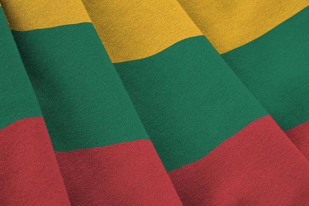 Lithuania flag with big folds waving close up under the studio light indoors The official symbols and colors in banner