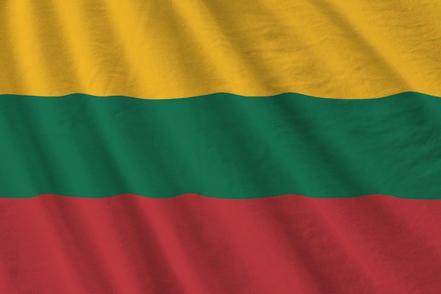 Lithuania flag with big folds waving close up under the studio light indoors The official symbols and colors in banner