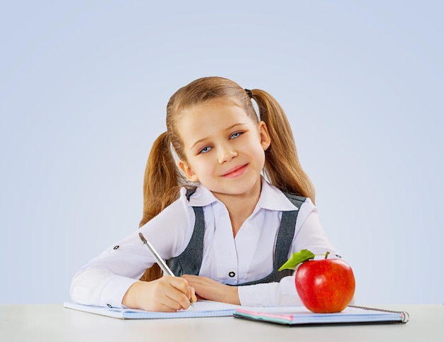 A litle shoolgirl writing in her notebook