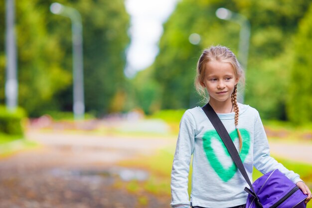 Little adorable girl going to the gym with her sports bag