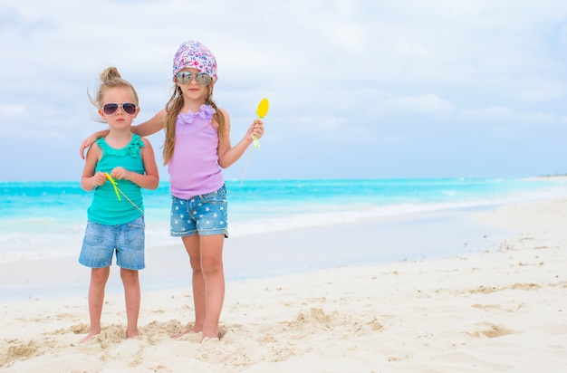 Little adorable girls during tropical beach vacation