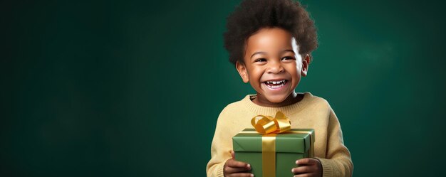 A little african boy is unwrapping a gift and laughs on red background Banner copy space Generative ai