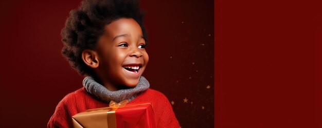 A little african boy is unwrapping a gift and laughs on red background Banner copy space Generative ai