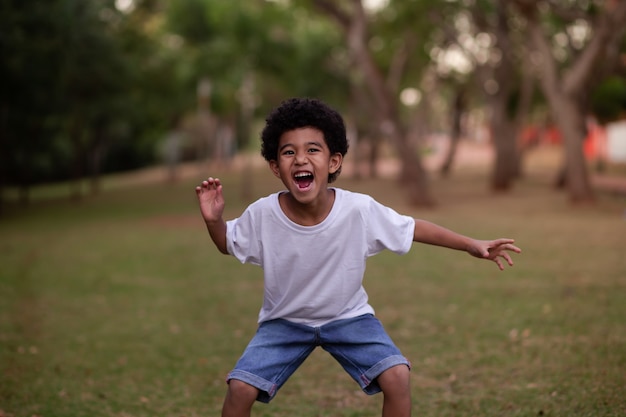 Little afro boy grimacing at camera