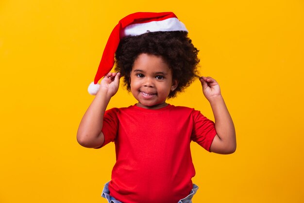 Little afro girl child with Santa Claus hat.