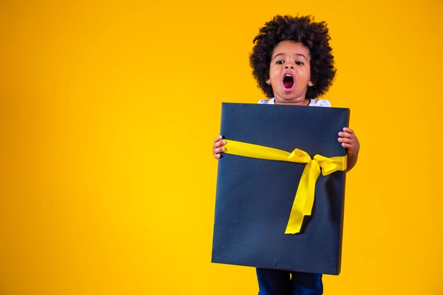 Little afro girl with a big gift in her hands