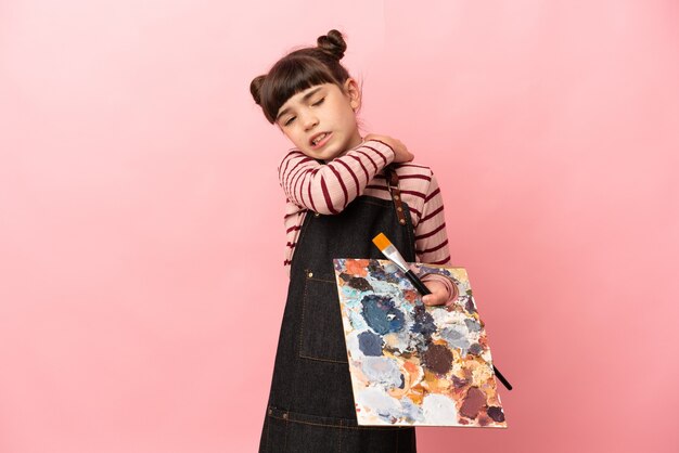 Little artist girl holding a palette isolated