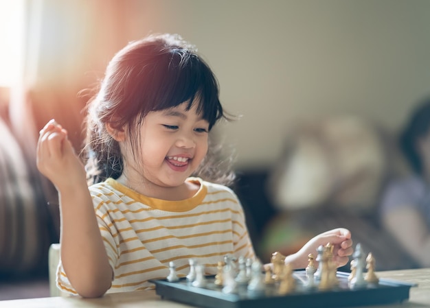 Little asian baby playing chess in the living room at homeSmart kidfashion children Little genius Child Intelligent gameChessboard Baby activity concept