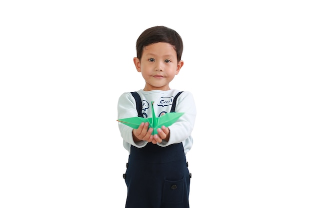 Little Asian boy holding origami bird isolated on white background. Focus at baby face. Freedom concept